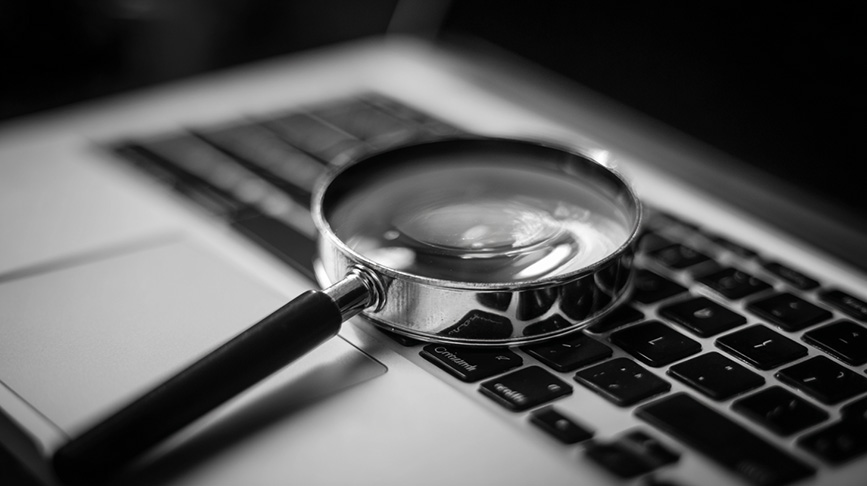 magnify glass over a laptop